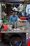 Vietnamese female chef cook noodles soup at outdoor restaurant from mobile food stall