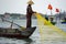 vietnamese fisherman fishing with net