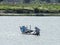 Vietnamese fishermen on a boat catching fish, Mekong river delta area