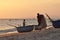 Vietnamese fishers at work with fishing nets at sunset