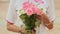 Vietnamese girl holding a bouquet of pink roses