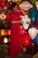 Vietnamese girl in red dress sells souvenir Chinese lanterns