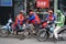 Vietnamese guys rest on motorbike taxi on street in old town Hanoi , Vietnam