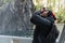 Vietnamese man taking photo looking up in Milford Sound cruise ship