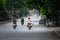 Vietnamese man transports piglets on a motorbike at a market