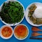 Vietnamese meal, boiled vegetables, tofu cheese, tomato soup, fried egg with mugwort