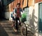 Vietnamese mother transport daughter go to school by bicycle in hot sunshine day