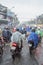 Vietnamese riders keep on going under the rain on a street of Ho Chi Minh City, Vietnam