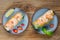 Vietnamese spring rolls with shrimps on two plates on wooden background