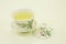 Vietnamese tea. Green Tea Phat Do.Tea in a beautiful traditional oriental cup with saucer. Isolated in a white bowl on a white