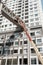 Vietnamese technician in crane truck of maintenance services to repair sky bridge of apartment building