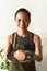 Vietnamese waitress smiles and holding plate of guava cake