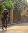 Vietnamese woman bicycling in Hoi An
