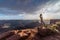 A Vietnamese woman in her wedding dress poses in the barren desert of Moab, Utah