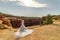 A Vietnamese woman in her wedding dress poses in the barren desert of Moab, Utah