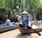 Vietnamese Woman Paddling a Wooden Boat in the Mekong Delta