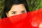 Vietnamese woman peeking over red fabric