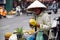 Vietnamese woman peeling pineapple fruit on the street