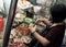 Vietnamese woman sell Vietnam bread on cart at night street food