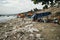 Vietnamese woman throws garbage on the beach by the sea. Dump by the sea. bad ecology in Southeast Asia. Fishermen village in MUI