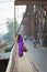 Vietnamese woman in traditional dress Ao Dai walking on old Long Bien bridge, Hanoi city