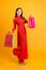 Vietnamese woman wearing ao dai hold shopping bag. Happy lunar new year