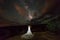 A Vietnamese woman in a wedding dress poses in the barren desert of Moab, Utah at night.