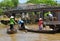 Vietnamese women in traditional boats row and shop near a floating market in Vietnam\'s Mekong Delta