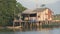 Vietnamese wooden house on stilts standing on the river