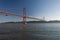 View of the 25 of April Bridge Ponde 25 de Abril with seagulls flying over the Tagus River, in the city of Lisbon
