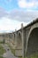 View of the abandoned old Mokrinsky railway bridge. Russia, the bridge was built in 1918. There are people under the bridge.