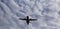 View from above on airplane in flight. Aircraft is flying in blue cloudy sky. Original sound.