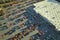 View from above of american grocery store with many parked cars on parking lot with lines and markings for parking