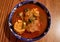 View from above of a blue ceramic plate with mole de olla, typical Mexican soup