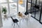 View from above on bright spacious black and white dining room with a big window