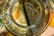 View from above directly into the big preserving jar with the fresh elderflowers, oranges and lemon slices and the vanilla pod