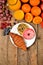 View from above of donuts, croissant, orange juice, blueberries, raspberries, apples - sweet breakfast on wooden table