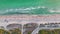 View from above of evening Blind Pass beach with white sands and relaxing tourists on Manasota Key, USA. People enjoying