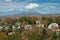 View from above of expensive residential houses high on hill top between yellow fall trees in suburban area in North