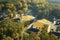 View from above of expensive residential houses between yellow fall trees in suburban area in South Carolina. American