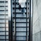 View from above on fast moving young man walking up an escalator stairs