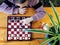 View from above. The girl learns to play table chess.Cultural leisure of children. Board games are an alternative to computer