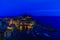 View from above hill of Vernazza bay and houses with lit light a