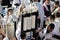 A view from above of a Jewish man wearing a tallit and a blue face mask Because of the corona virus , picking up a Torah scroll in