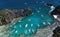 A view from above on a lagoon in which boats brought tourists for a rest. Aerial view of the turquoise water between the black st