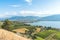View from above of orchards and vineyards with Okanagan Lake and city of Penticton in summer
