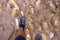 View from above on pair of trekking shoes in a mud, Hiking boots stuck in mud