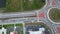 View from above of roundabout crossroads on american city street with moving traffic cars. Urban circular transportation