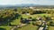 View from above of rural America in North Carolina. Big expensive residential house surrounded with farm fields and