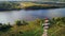 View from above structure supports overhead power line on lake bank